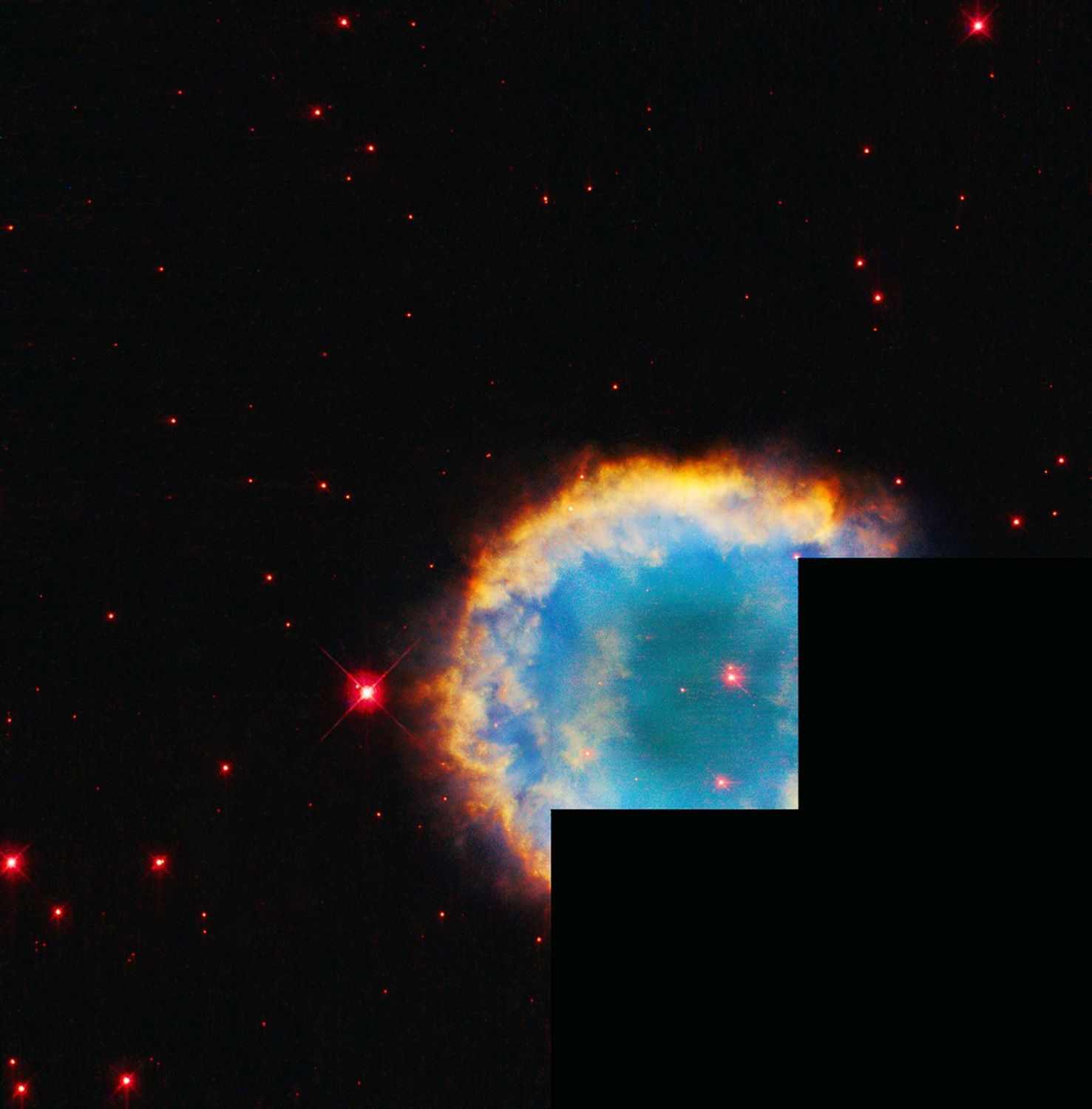 Circular nebula with reddish-white star at center, turquoise interior with hazy, cloudy yellow-orange and red rings around the center.